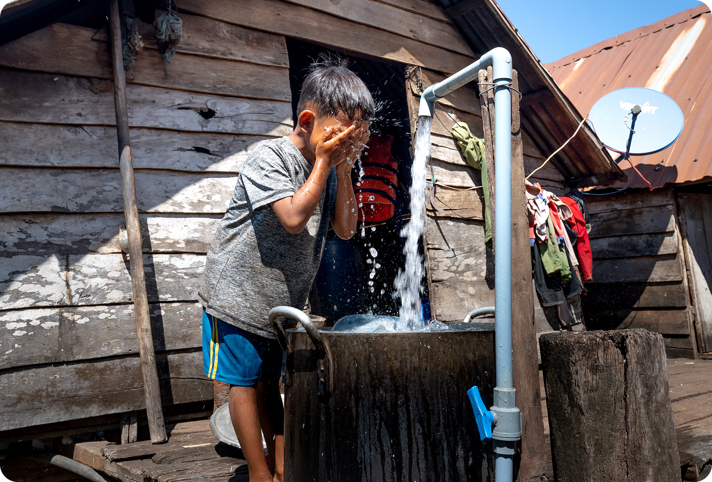 Boy washing face with clean water