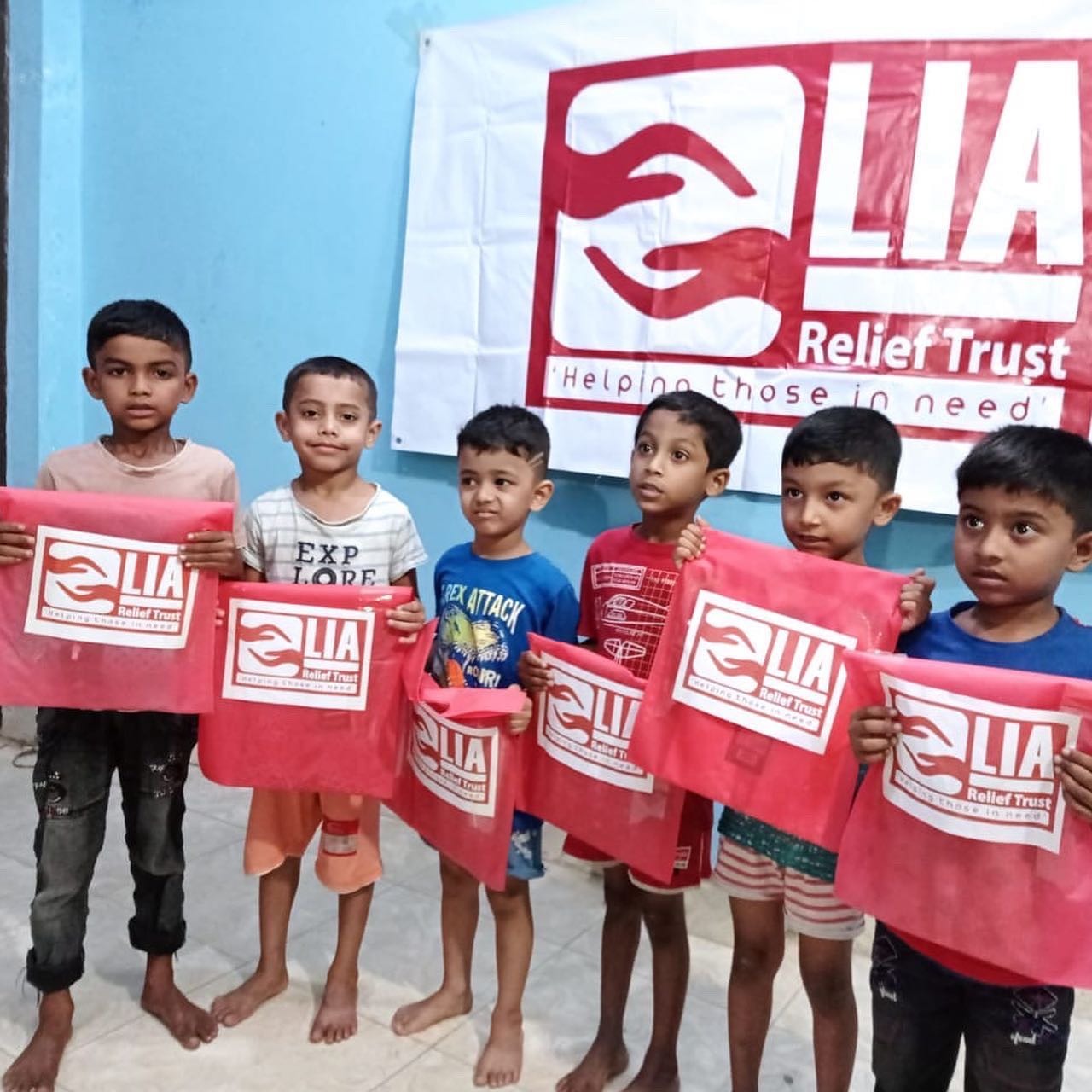 Children holding LIA relief bags